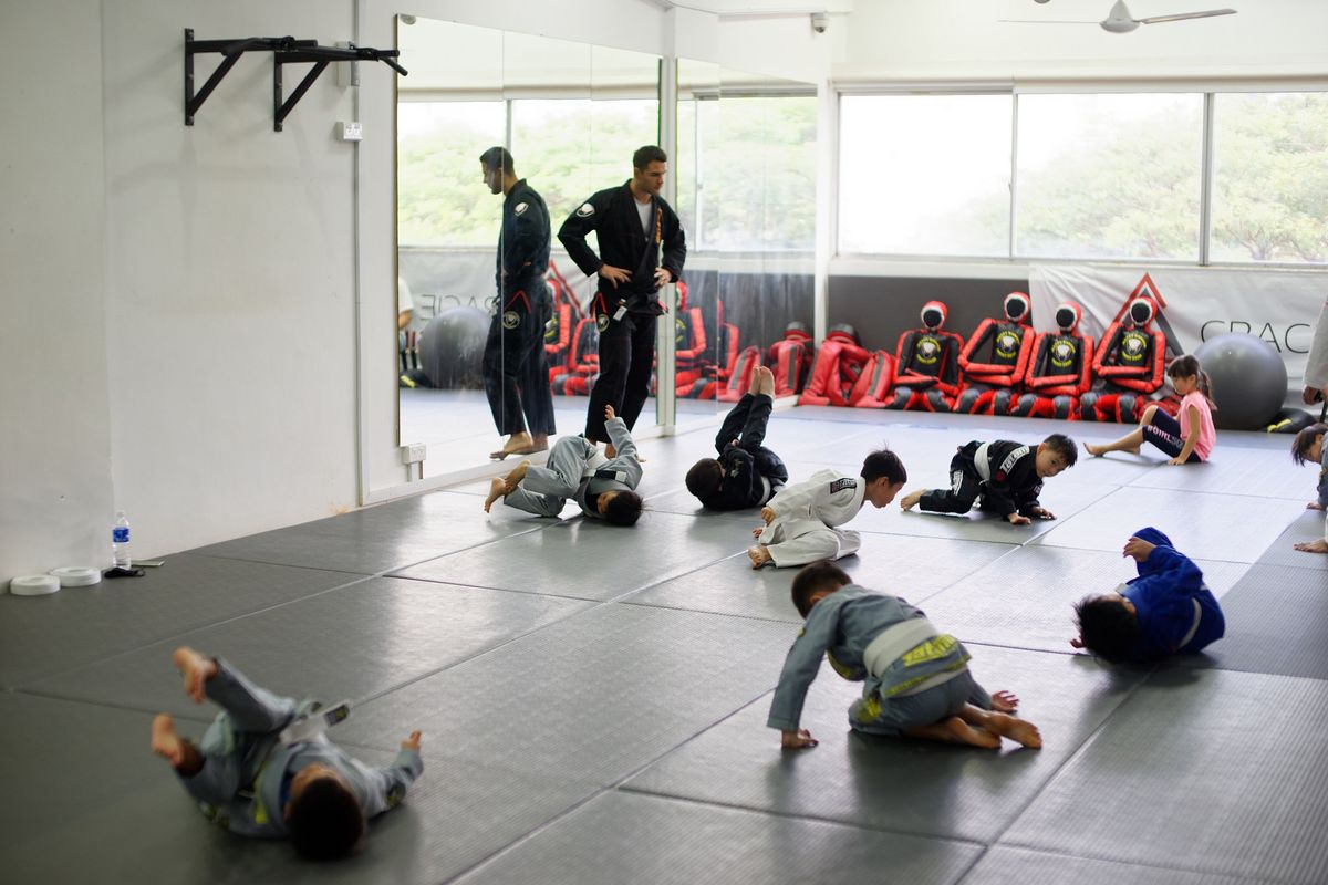Kids work through movement drills during the warm-up.