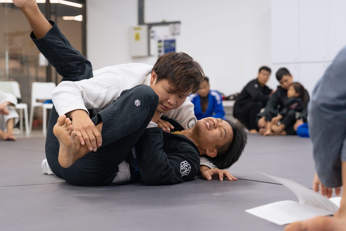 Training from guard, where the bottom player uses their legs to control their partner.